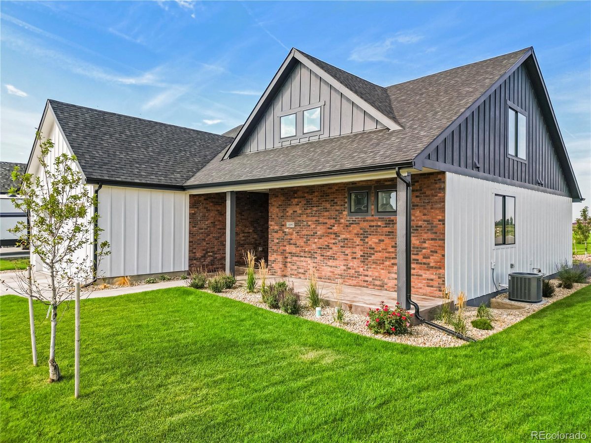 Front exterior of a two-story home with siding and brick accents
