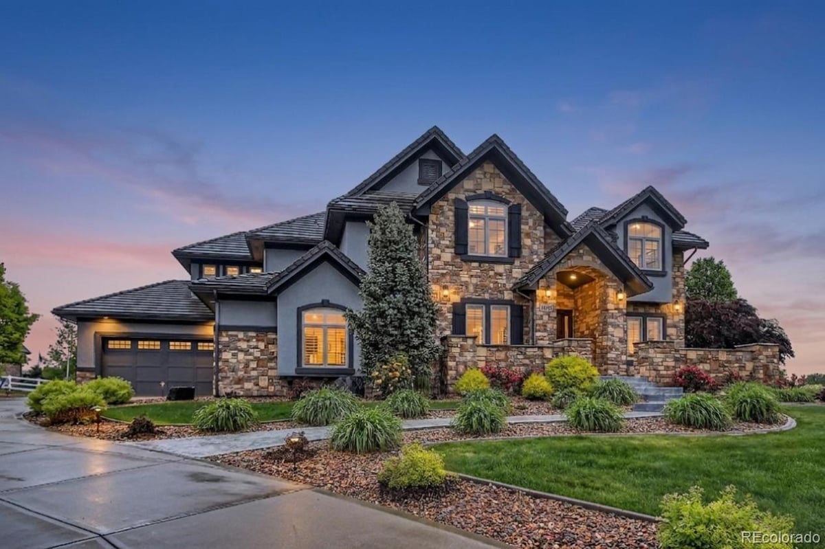 Front exterior of a two-story home with siding and brick accents