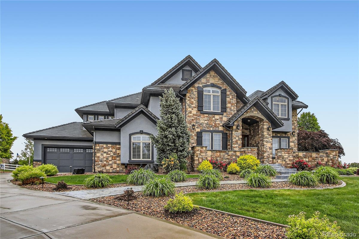Front exterior of a two-story home with siding and brick accents
