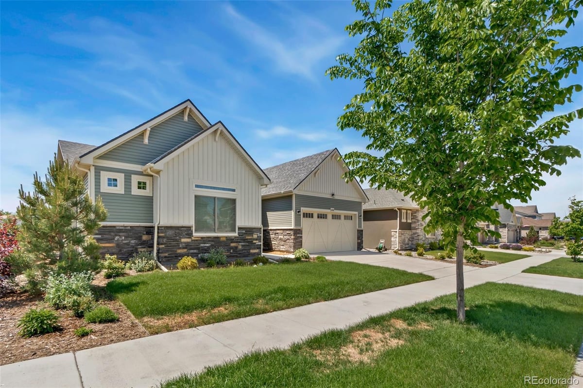 Front exterior of a two-story home with siding and brick accents