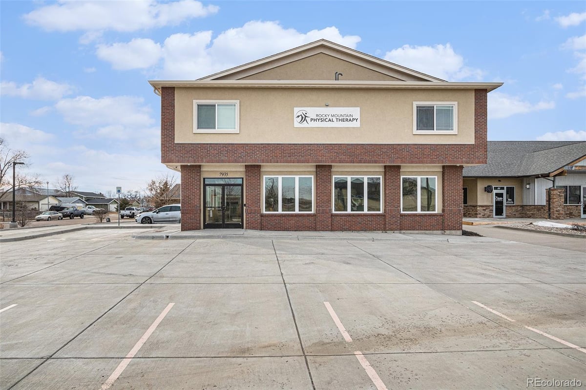 Front exterior of a two-story home with siding and brick accents