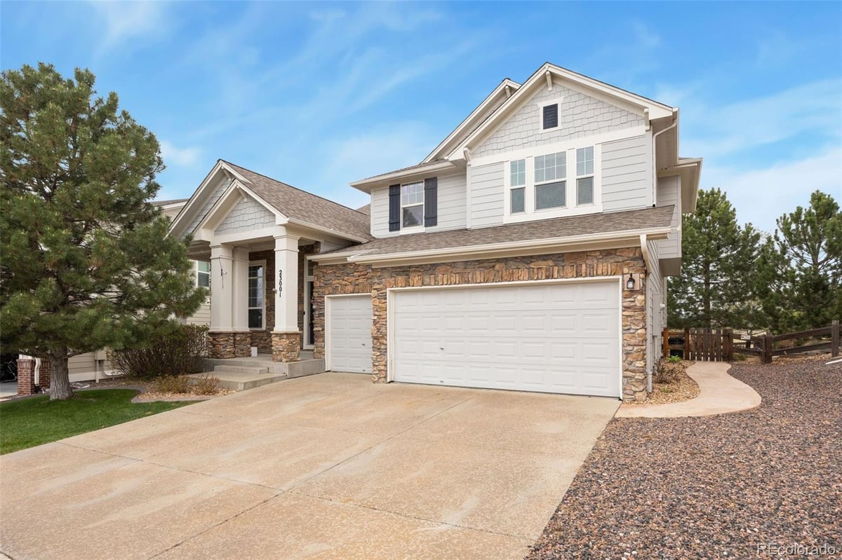 Front exterior of a two-story home with siding and brick accents