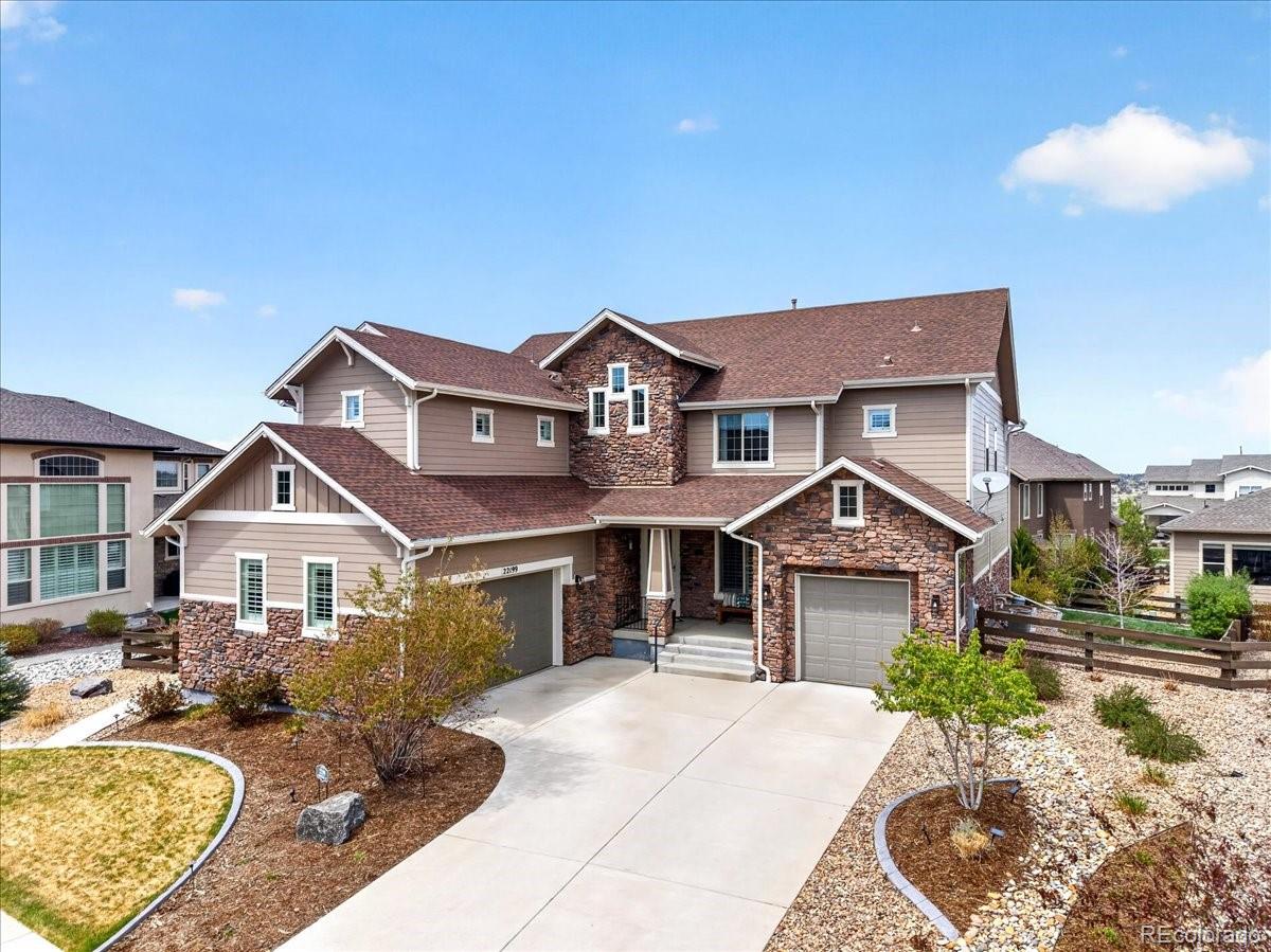 Front exterior of a two-story home with siding and brick accents