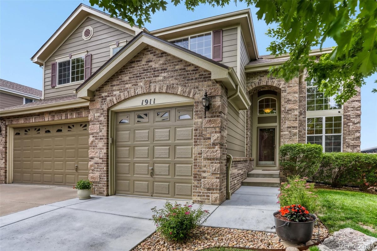 Front exterior of a two-story home with siding and brick accents