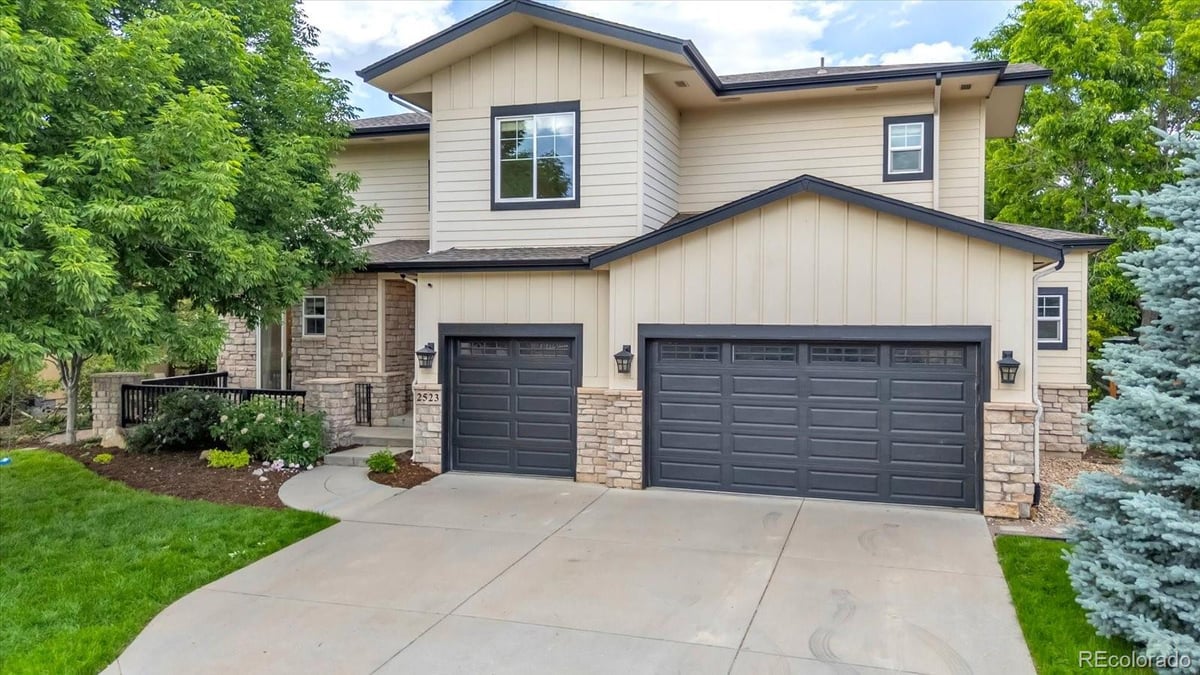 Front exterior of a two-story home with siding and brick accents