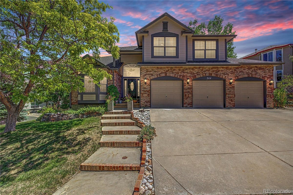 Front exterior of a two-story home with siding and brick accents